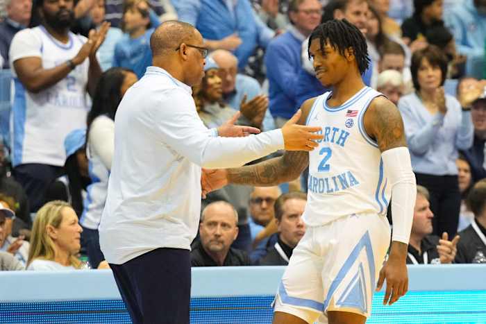 North Carolina Tar Heels coach Hubert Davis greets guard Caleb Love (2) after he come out of the game